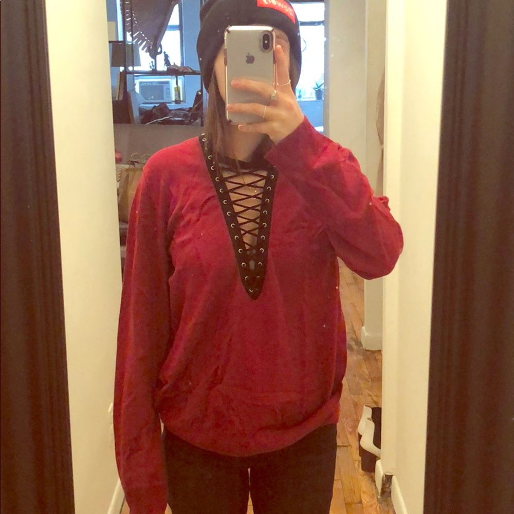 Red v neck sweater with black lace up front